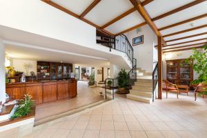 a living room with a staircase in a house at Hotel Villa Lina in Loano