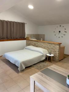 a bedroom with two beds and a clock on the wall at Apartments Piero in Zadar