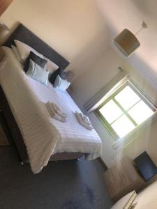 a bedroom with a large bed with a window at The Crossings in Carlisle