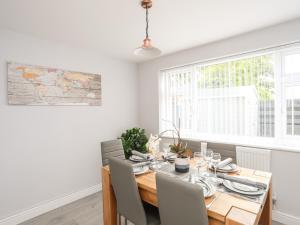 a dining room with a wooden table and chairs at Valley House in Holyhead