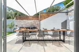 a patio with a long table and chairs at Villa Lydia in Rethymno