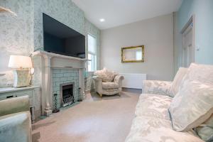 a living room with a couch and a fireplace at Saxon Lodge Cottage Felixstowe Air Manage Suffolk in Felixstowe