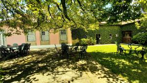 a group of chairs and tables in front of a building at Casa da Roseira in Ponte de Lima