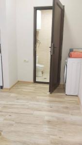 an open door to a bathroom with a toilet at Жемчужина у моря in Batumi +28 photos