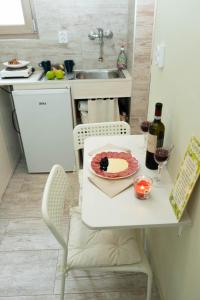 a kitchen with a table with a cake and wine bottles at HAPPY in Zagreb
