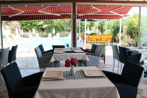a restaurant with tables and chairs and a pool at Casablanca Hotel in Dalyan