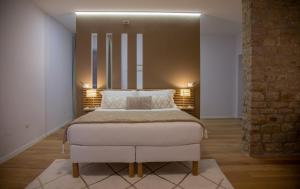 En eller flere senge i et værelse på La Piazzetta Suite