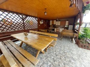 a room with wooden tables and benches in a building at Casa Olimpia 2 Mai in 2 Mai