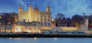 a large castle sitting on the side of a river at Luxury Private Mews Modern Apartment in the City in London