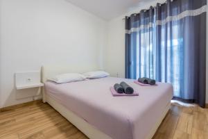 Posteľ alebo postele v izbe v ubytovaní Apartments Natalija