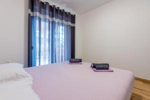 Posteľ alebo postele v izbe v ubytovaní Apartments Natalija