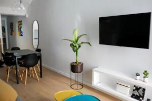 a living room with a table and a plant on a wall at Casa Chiara in Cefalù