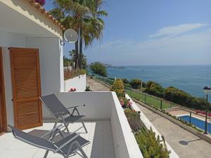 two chairs on a balcony with a view of the ocean at Rayos de Sol in Peñíscola