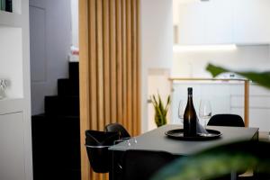 a bottle of wine on a table with chairs at Casa Chiara in Cefalù