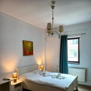 a bedroom with a white bed and a window at Adrys Boutique Villa in Constanţa