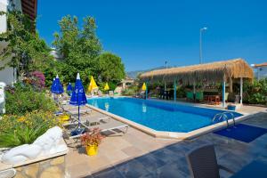 a large swimming pool with chairs and umbrellas at Casablanca Hotel in Dalyan