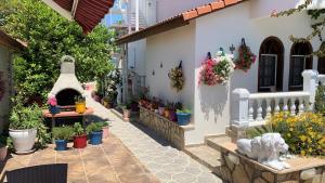 a courtyard with potted plants and a house at Casablanca Hotel in Dalyan