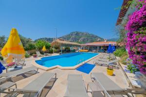 a resort with a swimming pool and lounge chairs at Casablanca Hotel in Dalyan