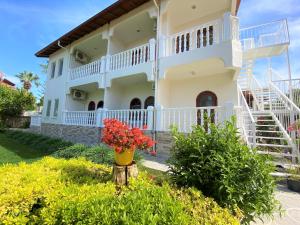 a large white house with a vase of flowers at Casablanca Hotel in Dalyan