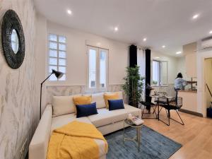 a living room with a white couch and a table at MOLINA - LA LATINA in Madrid