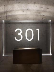 a neon sign with the number on a wall at Hotel NERU con Encanto in León
