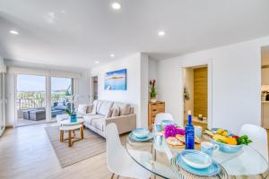 a living room with a table and chairs and a couch at Ideal Property Mallorca - Blue Sky in Alcudia