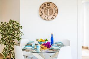 a dining room table with a plate on the wall at Ideal Property Mallorca - Blue Sky in Alcudia