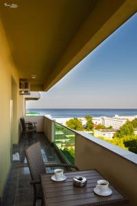 a balcony with a table and a view of the beach at SARA Moonlight Residence in Mamaia