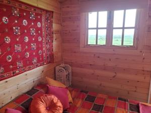 a bedroom with a bed in a wooden room at Healing Waters Sanctuary for Exclusive Private Hire and Self Catering Board, Vegetarian, Alcohol & Wifi Free Retreat in Glastonbury in Glastonbury