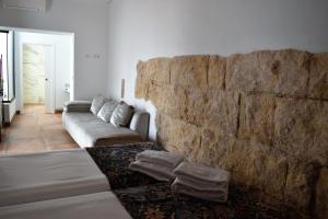 a living room with a couch and a stone wall at Patio San Andrés in Córdoba