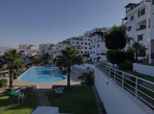 a view from the balcony of a apartment with a swimming pool at Belle appartement de vacances avec vue sur mer in Tétouan