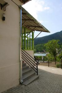 a building with a staircase leading up to a door at Polifonia Inn Borjomi in Borjomi