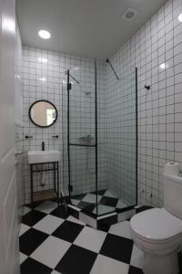 a bathroom with a toilet and a sink at Polifonia Inn Borjomi in Borjomi