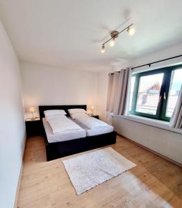 a bedroom with two beds and a window at Ferienwohnung Staufenblick in Piding