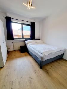 a bedroom with a bed and a large window at Ferienwohnung Staufenblick in Piding