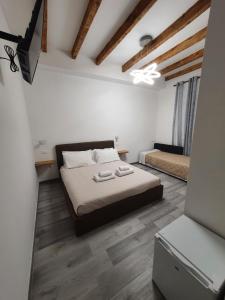 a bedroom with a bed with two towels on it at 5 Terre Station Rooms in La Spezia