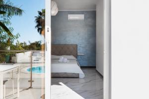 a bedroom and a balcony with a bed and a table at B&B El Dorado in Palinuro +197 photos
