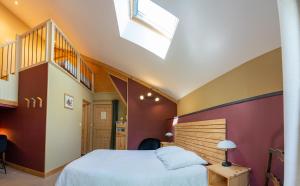 a bedroom with a bed and a staircase at Les Balcons de la Terrasse in Arsac-en-Velay