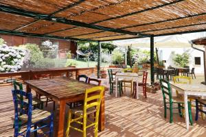 een terras met tafels en stoelen en een houten terras bij Casa Rosaria in Vietri