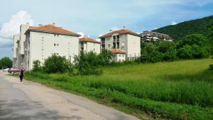 a man walking down a road next to buildings at Studio La Casa in Soko Banja