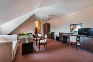 a living room with a couch and a table at Centrum Wypoczynku i Rehabilitacji Umina in Czorsztyn