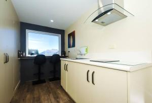 a kitchen with a sink and a window at Lovely Apartment- Amazing Lake & Mountain Views in Queenstown