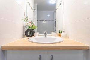 a bathroom with a sink and a mirror at Ô Rêves Bleus in Saint-François +13 photos
