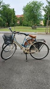 a bike with a basket parked on the street at apartment GiòHome in Grado