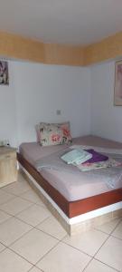 a bed in a room with a white wall at Ground Floor Studio Galini in Rethymno