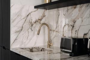 a kitchen counter with a sink and a microwave at HIGHSTAY - Luxury Serviced Apartments - North Marais 1 in Paris +56 photos