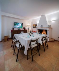 Montalto delle MarcheにあるRecchi Franceschini Bike Hotel LAST - MINUTE - AVAILABILITYのテーブルと暖炉付きの広いダイニングルーム
