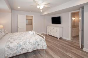 a bedroom with a bed and a flat screen tv at Lazy Day-Z in Virginia Beach