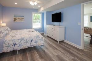 a bedroom with a bed and a television on a dresser at Lazy Day-Z in Virginia Beach