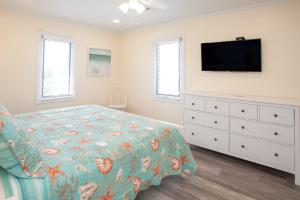 a bedroom with a bed and a flat screen tv at Lazy Day-Z in Virginia Beach